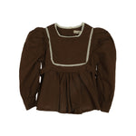 Raina blouse in brown. Brand: Amber Colour: Brown Details: Square neck, Lace, Ribbon at the back for slime fit, Puffy sleeves, Buttons at the back, Buttons at wrists Composition: 100% Cotton Made in: Korea