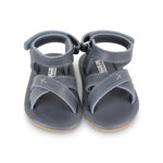 Goggles summer baby sandals. Brand: Donsje Colour: Grey Classic  Details: Handmade & Fairtrade, Adjustable velcro fastening strap Anti slip suede outsole (size: 0-6 & 6-12 months),  Rubber flexible sole (size: 12-18 & 18-24 months) Composition:  100% Premium leather